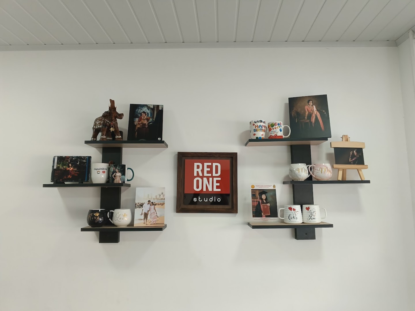 Printed mugs and framed keepsakes on the display shelf